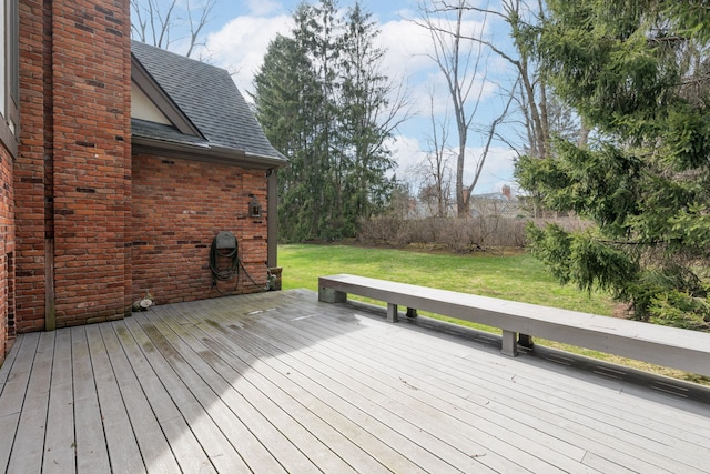 wooden terrace featuring a yard