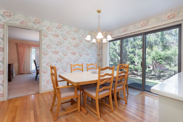 dining space with a notable chandelier, light hardwood / wood-style floors, and a healthy amount of sunlight