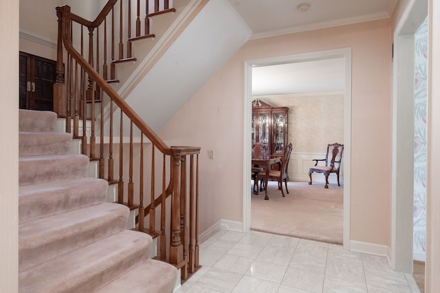 staircase featuring carpet flooring and ornamental molding