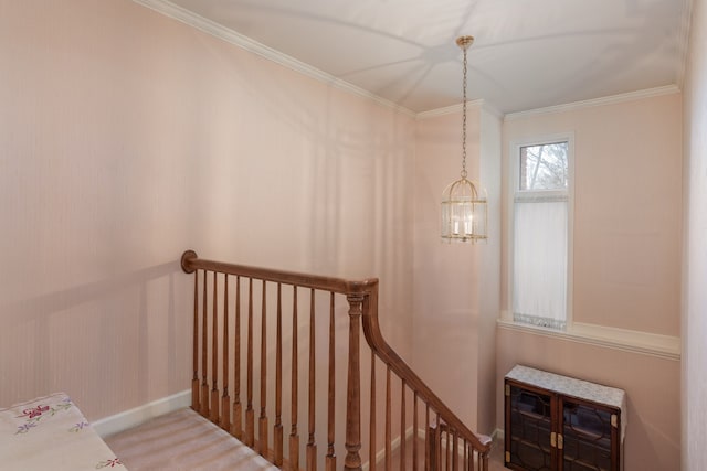 stairs featuring carpet flooring, ornamental molding, and a chandelier