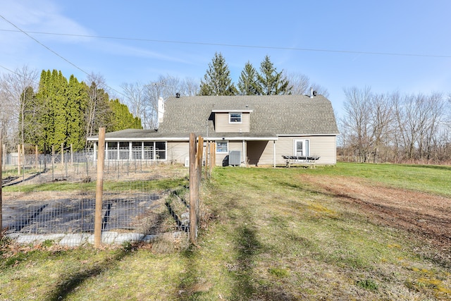 back of property featuring a lawn