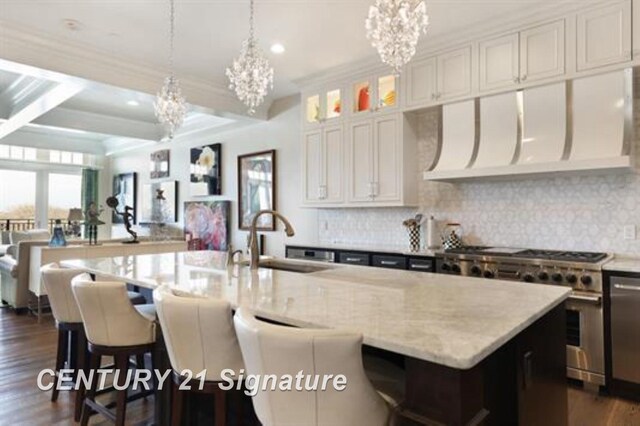 110 E Main St, Midland, MI 48640 - kitchen featuring a sink, a chandelier, high end stainless steel range, ventilation hood, and dark wood-style floors