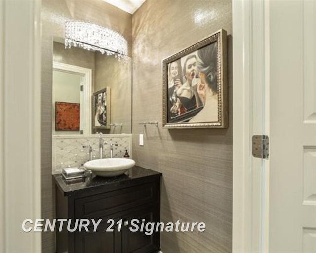 bathroom featuring vanity and tile walls