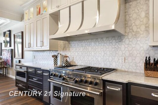 110 E Main St, Midland, MI 48640 - kitchen featuring stainless steel appliances, ventilation hood, white cabinetry, dark wood-style flooring, and glass insert cabinets