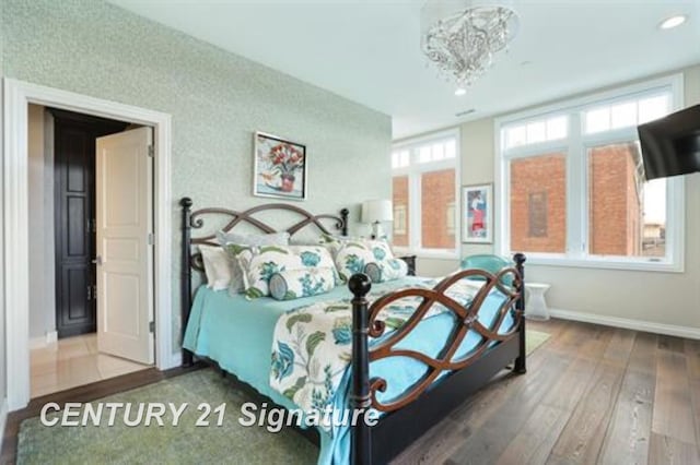 110 E Main St, Midland, MI 48640 - bedroom featuring hardwood / wood-style floors, baseboards, recessed lighting, and a chandelier