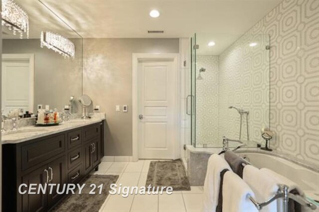 110 E Main St, Midland, MI 48640 - full bathroom with double vanity, a bath, a shower stall, tile patterned floors, and baseboards