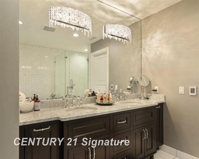 110 E Main St, Midland, MI 48640 - bathroom with double vanity, tile patterned flooring, and an enclosed shower