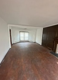 unfurnished living room with dark hardwood / wood-style floors