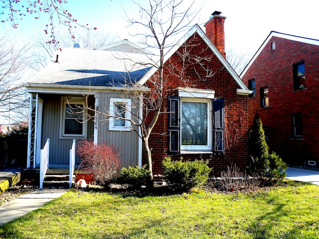 bungalow-style house with a front lawn