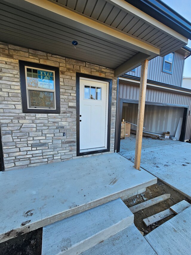 property entrance featuring stone siding