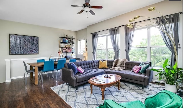 living room with baseboards, ceiling fan, and wood finished floors