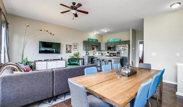 dining area with dark wood-style floors, baseboards, and ceiling fan