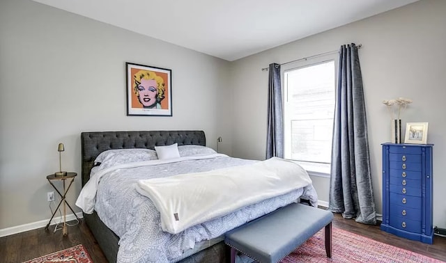 bedroom featuring wood finished floors and baseboards