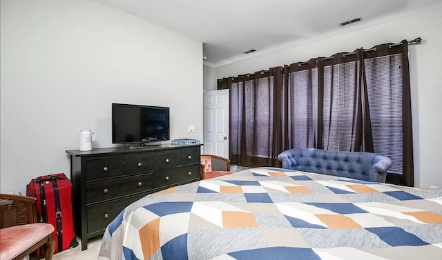 bedroom with light colored carpet and visible vents