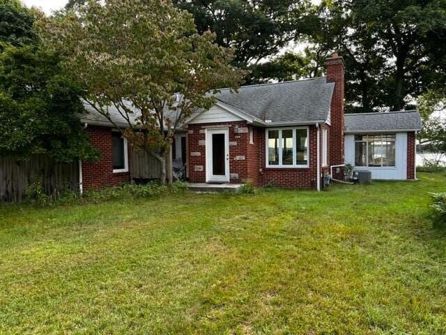 rear view of house with a lawn