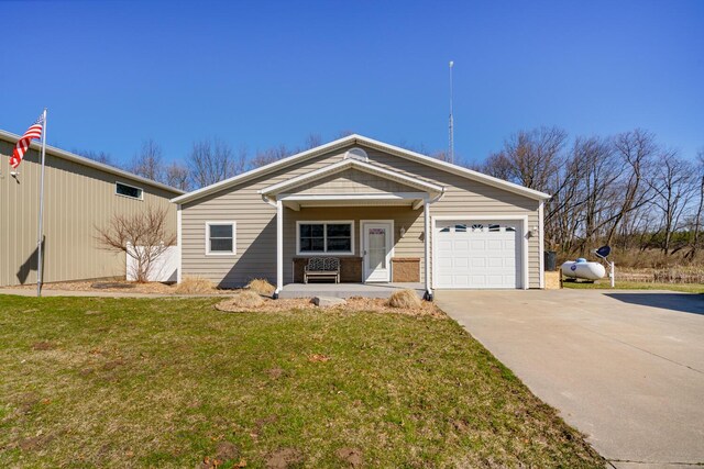 9363 S Grow Rd, Greenville, MI 48838 - view of front facade with an attached garage, concrete driveway, a front yard, and covered porch