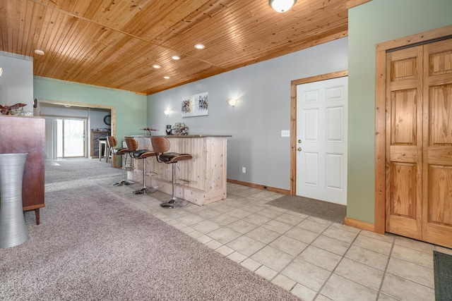 9363 S Grow Rd, Greenville, MI 48838 - indoor dry bar with wood ceiling, light tile patterned floors, recessed lighting, baseboards, and light colored carpet