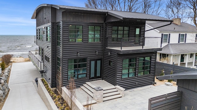 443 N Shore Dr, South Haven, MI 49090 - back of house with a balcony, view of water and beach, metal roof, and a standing seam roof