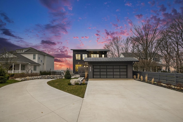 443 N Shore Dr, South Haven, MI 49090 - modern home with concrete driveway, metal roof, a standing seam roof, and a garage