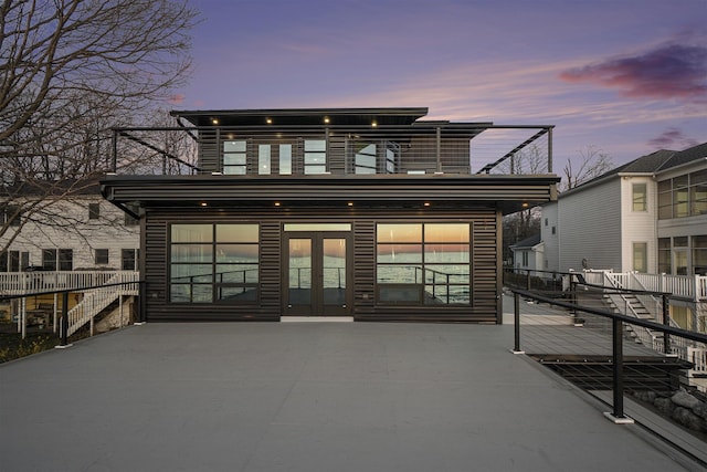 443 N Shore Dr, South Haven, MI 49090 - back of property at dusk with a balcony and french doors