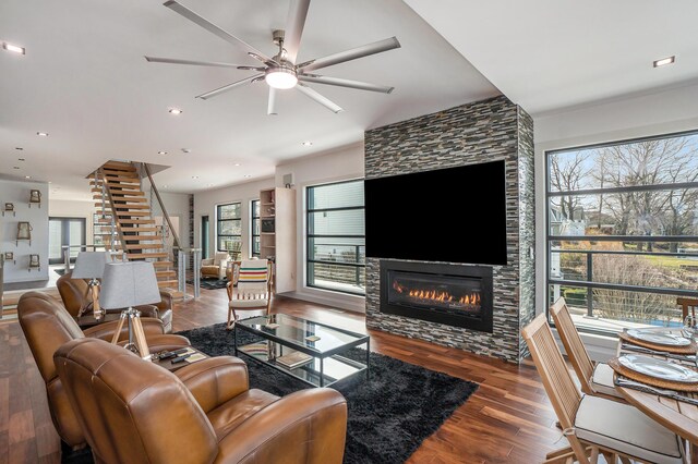 443 N Shore Dr, South Haven, MI 49090 - living room with wood finished floors, a tiled fireplace, stairway, ceiling fan, and recessed lighting