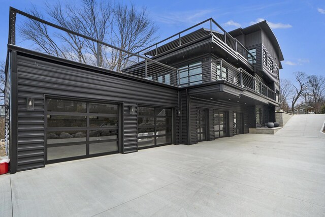 443 N Shore Dr, South Haven, MI 49090 - view of home's exterior with a balcony, driveway, and a garage