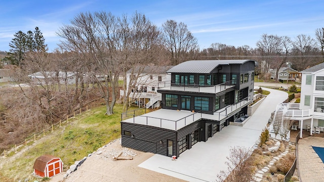 443 N Shore Dr, South Haven, MI 49090 - rear view of house featuring a balcony and a standing seam roof