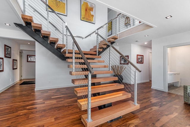 443 N Shore Dr, South Haven, MI 49090 - stairway featuring wood finished floors, a high ceiling, recessed lighting, and baseboards