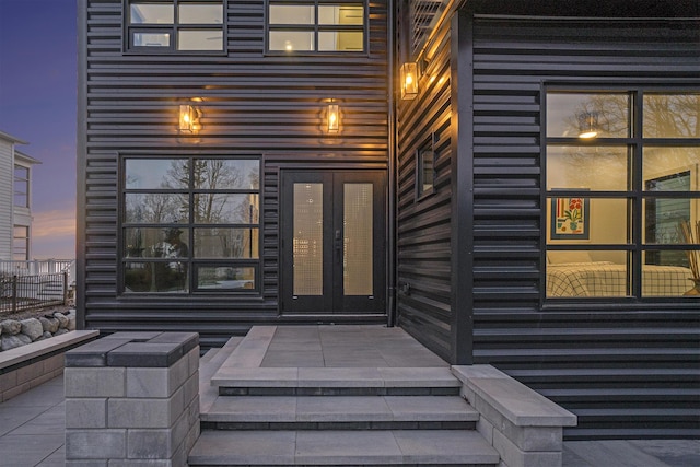 443 N Shore Dr, South Haven, MI 49090 - exterior entry at dusk featuring french doors