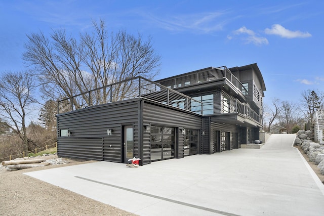 443 N Shore Dr, South Haven, MI 49090 - view of property exterior with a balcony, driveway, and an attached garage