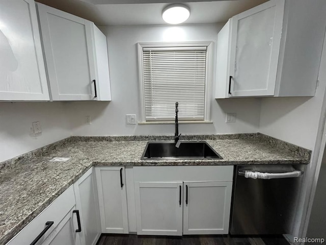 kitchen featuring dark hardwood / wood-style flooring, dishwasher, sink, and white cabinets