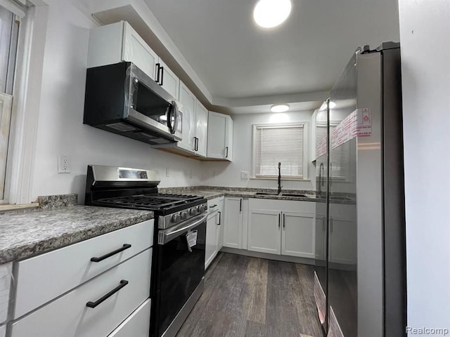 kitchen with sink, white cabinets, and stainless steel appliances