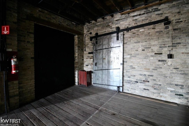 spare room with hardwood / wood-style floors and a barn door