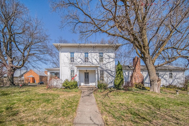 italianate home featuring a front yard