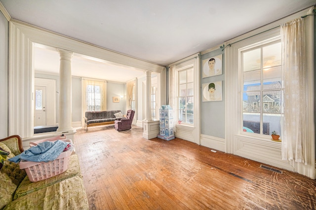 sunroom / solarium featuring decorative columns