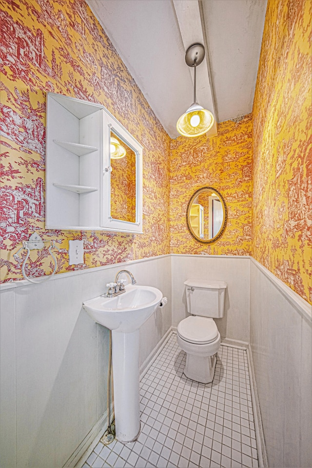 bathroom with tile patterned floors, toilet, and sink