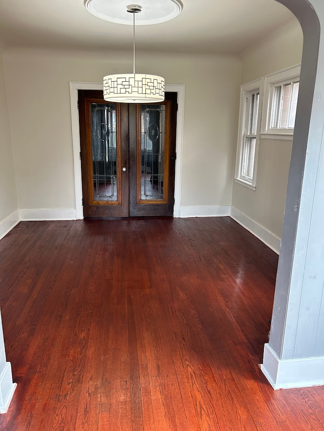 unfurnished dining area featuring dark hardwood / wood-style floors