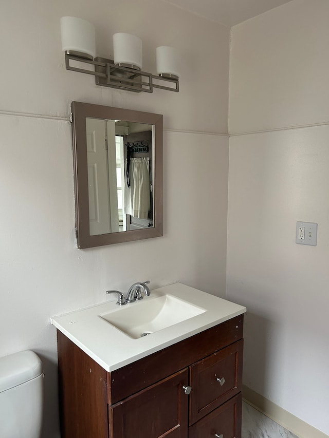 bathroom featuring vanity and toilet