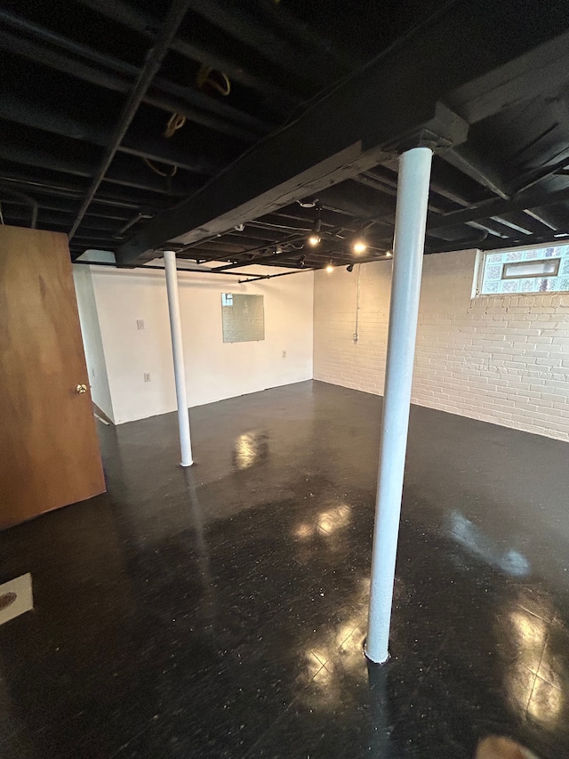 basement featuring brick wall