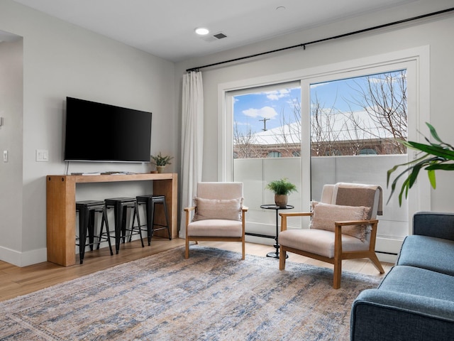 living area with hardwood / wood-style flooring