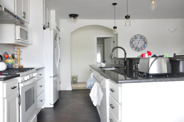 kitchen featuring sink, white cabinets, pendant lighting, and white appliances