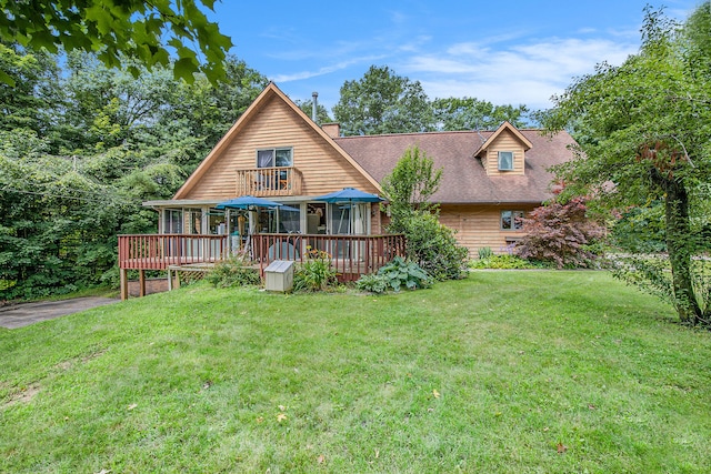 back of house with a yard and a deck