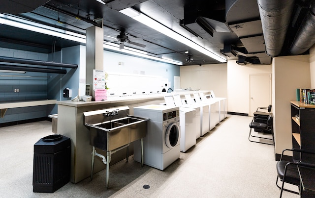 laundry area featuring ceiling fan, independent washer and dryer, and sink