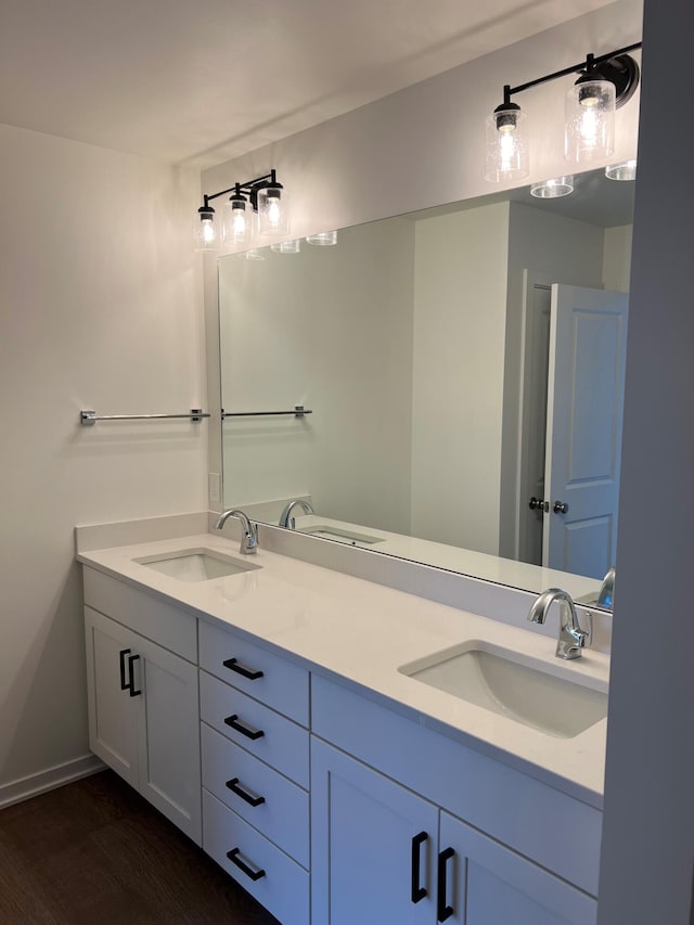 bathroom with hardwood / wood-style floors and vanity