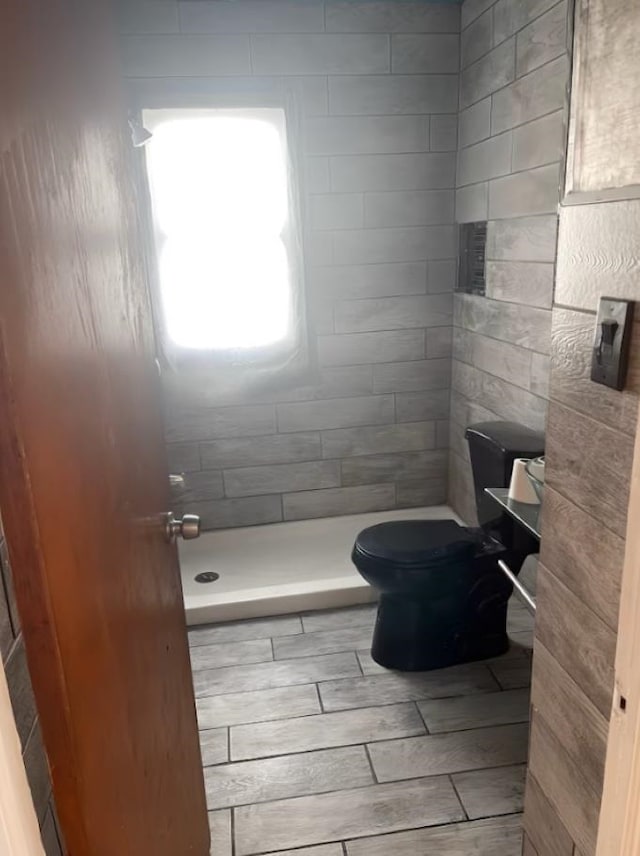 bathroom featuring toilet and a shower