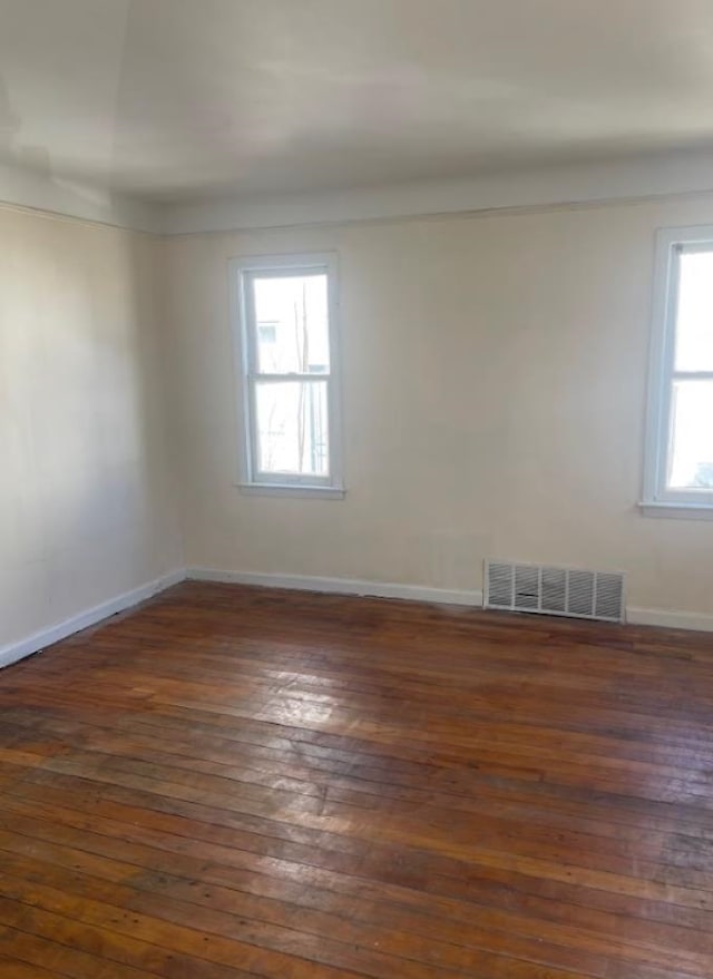 unfurnished room featuring dark hardwood / wood-style flooring