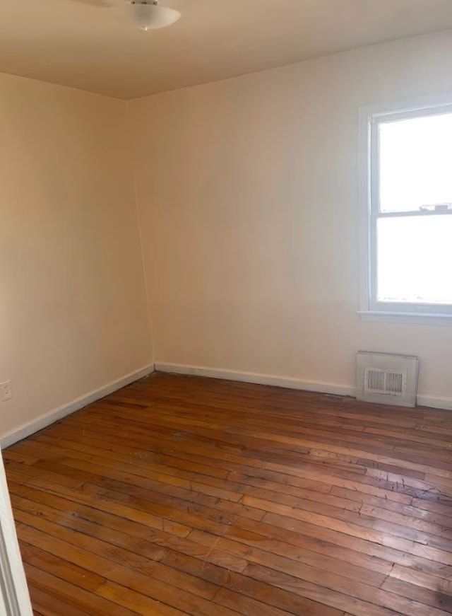 empty room with hardwood / wood-style floors