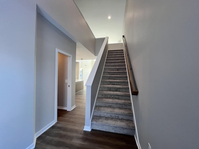 stairs with baseboards and wood finished floors