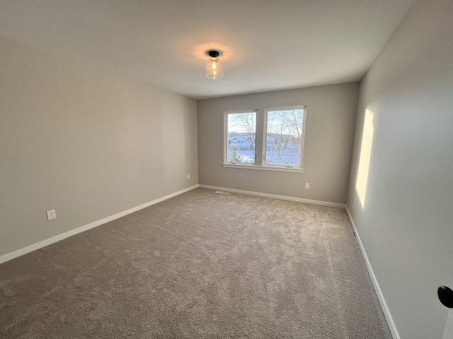 spare room with carpet flooring and baseboards