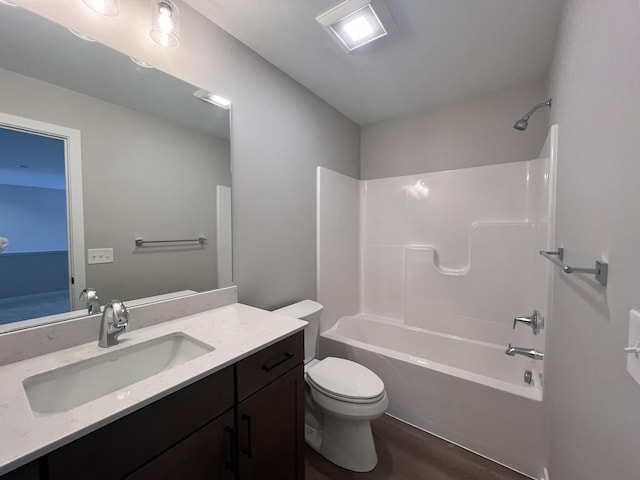 bathroom with  shower combination, vanity, toilet, and wood finished floors